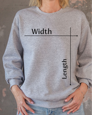 Gray sweatshirt with text and measurements on a person wearing it against a gray background