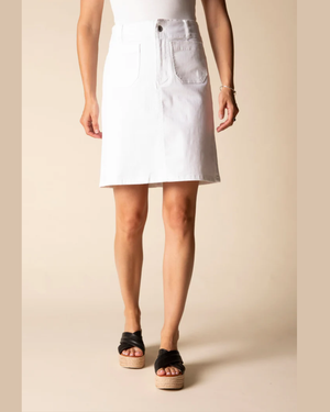 Person wearing a white denim skirt on a beige background