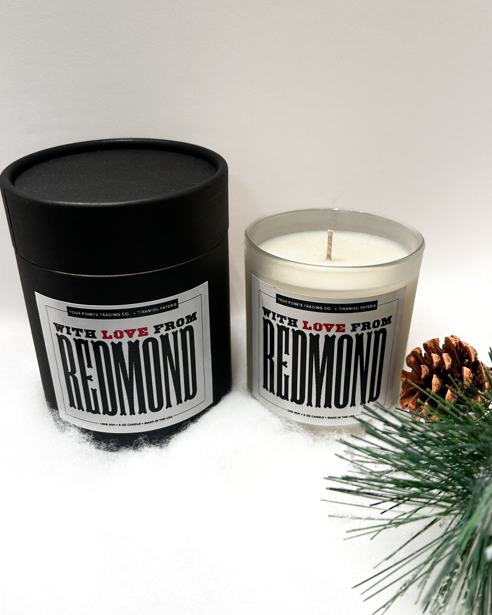 Candle and packaging with 'Redmond' branding on a white background