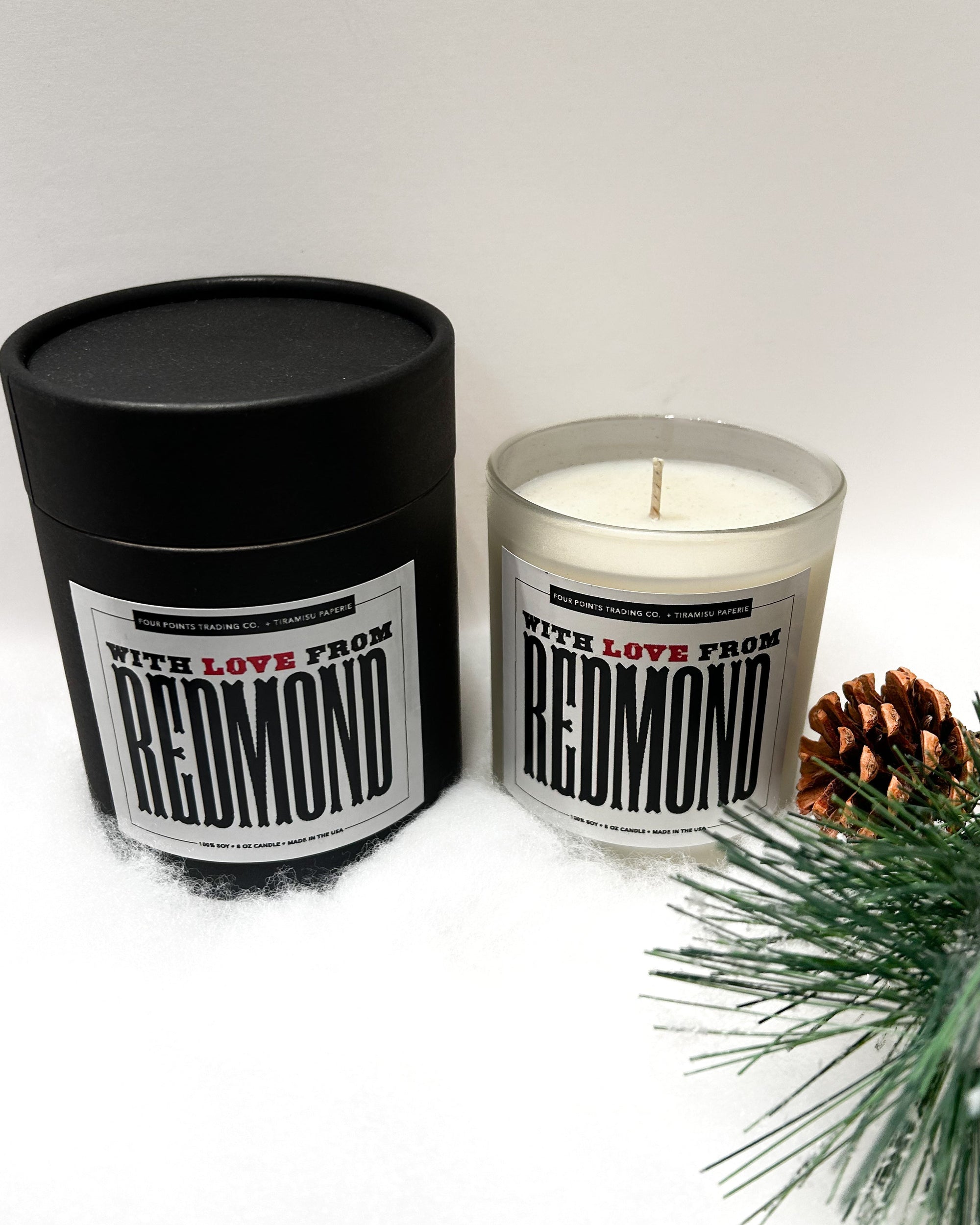 Candle and packaging with 'Redmond' branding on a white background