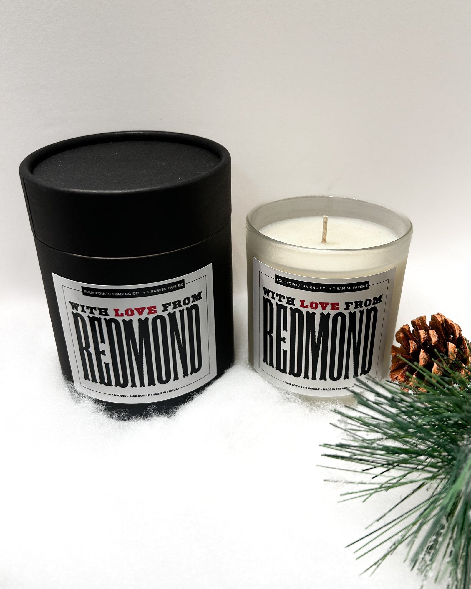 Candle and packaging with 'Redmond' branding on a white background
