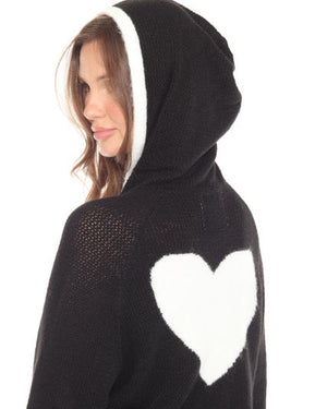 Person wearing a black outfit with white heart design on a white background
