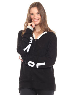 Woman wearing a black hoodie with white designs on a white background