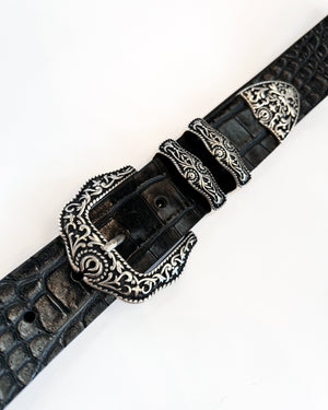 Black leather belt with silver buckle on a white background
