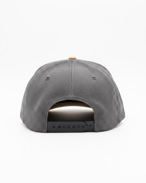 Gray cap on a wooden surface with a neutral background