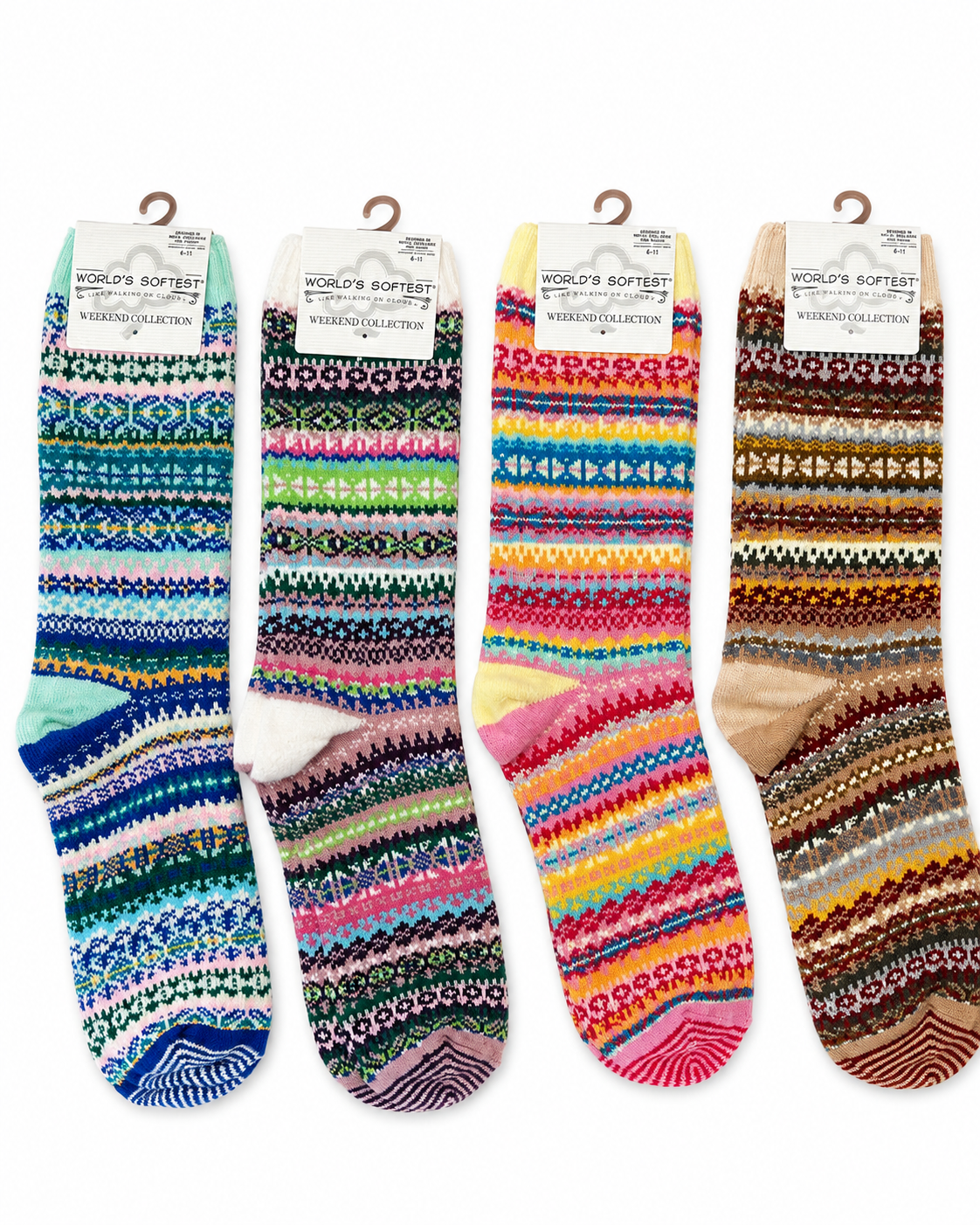 Four pairs of patterned knit socks hanging on wooden hangers against a plain white background. Each pair has a white paper header card with the text 'WORLD'S SOFTEST Socks' and 'WINTER COLLECTION'.