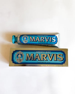 A tube and box of Marvis Aquatic Mint toothpaste on a plain white background.
