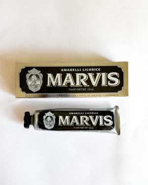 A tube and box of Amarelli Licorice Marvis toothpaste on a plain white background.