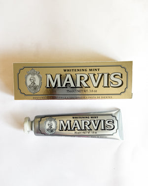 A tube and box of Marvis Whitening Mint toothpaste on a plain white background.