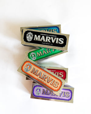 Five stacked Marvis cigarette packs in different colors (blue, black, green, orange, purple) on a plain white background.