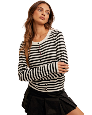 Woman wearing a black and white striped long-sleeve shirt on a white background