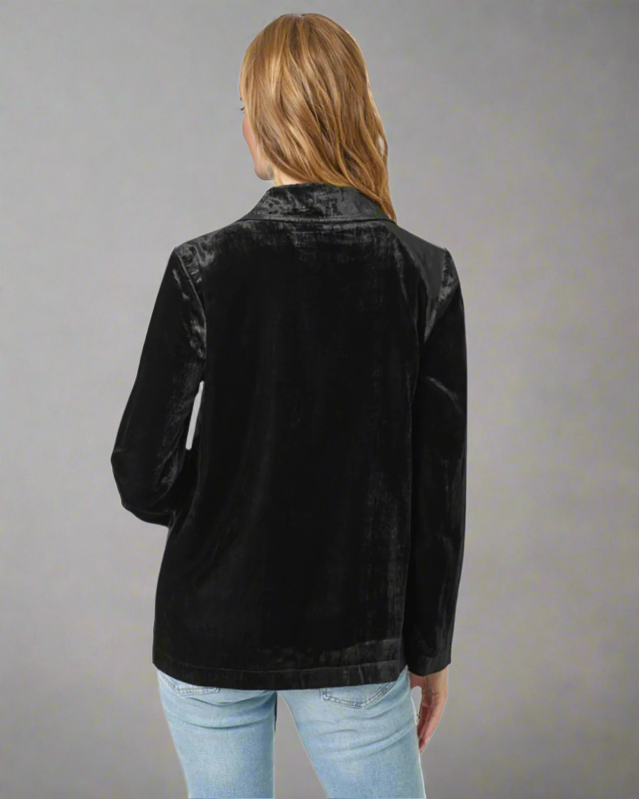 Black velvet jacket worn by a person on a white background