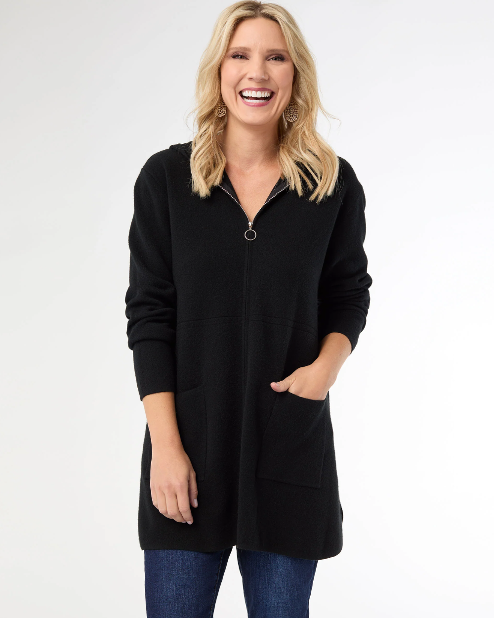 Woman wearing a black zip-up hoodie on a white background