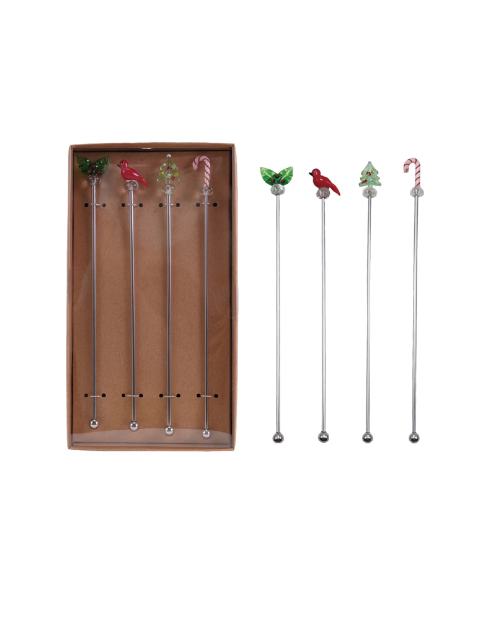 Set of decorative cocktail stirrers with a box on a light background