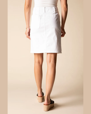 Person wearing a white skirt on a beige background