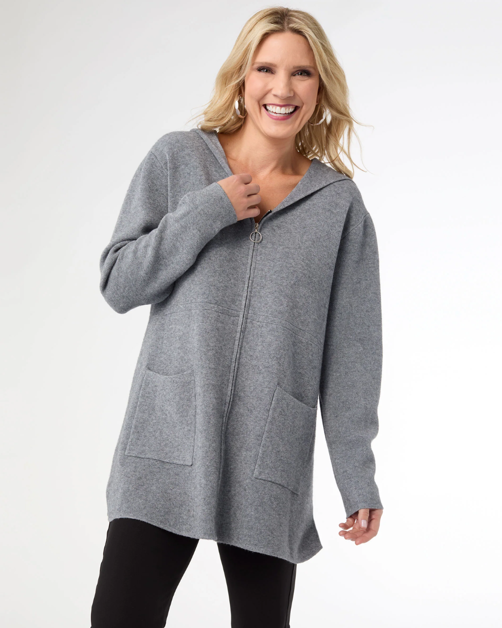 Woman wearing a gray zip-up hoodie on a white background