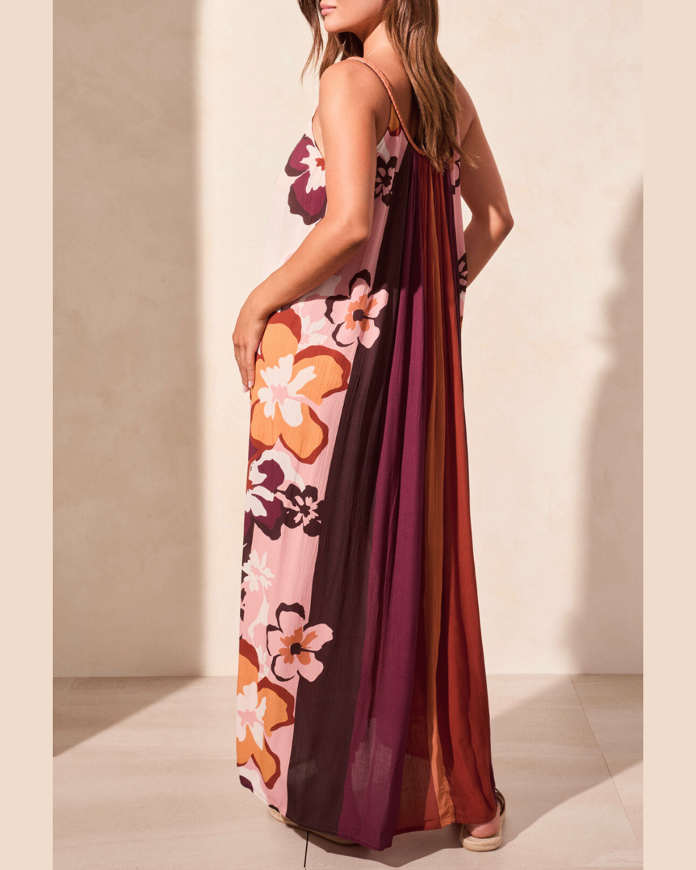 Woman wearing a floral dress with a neutral background