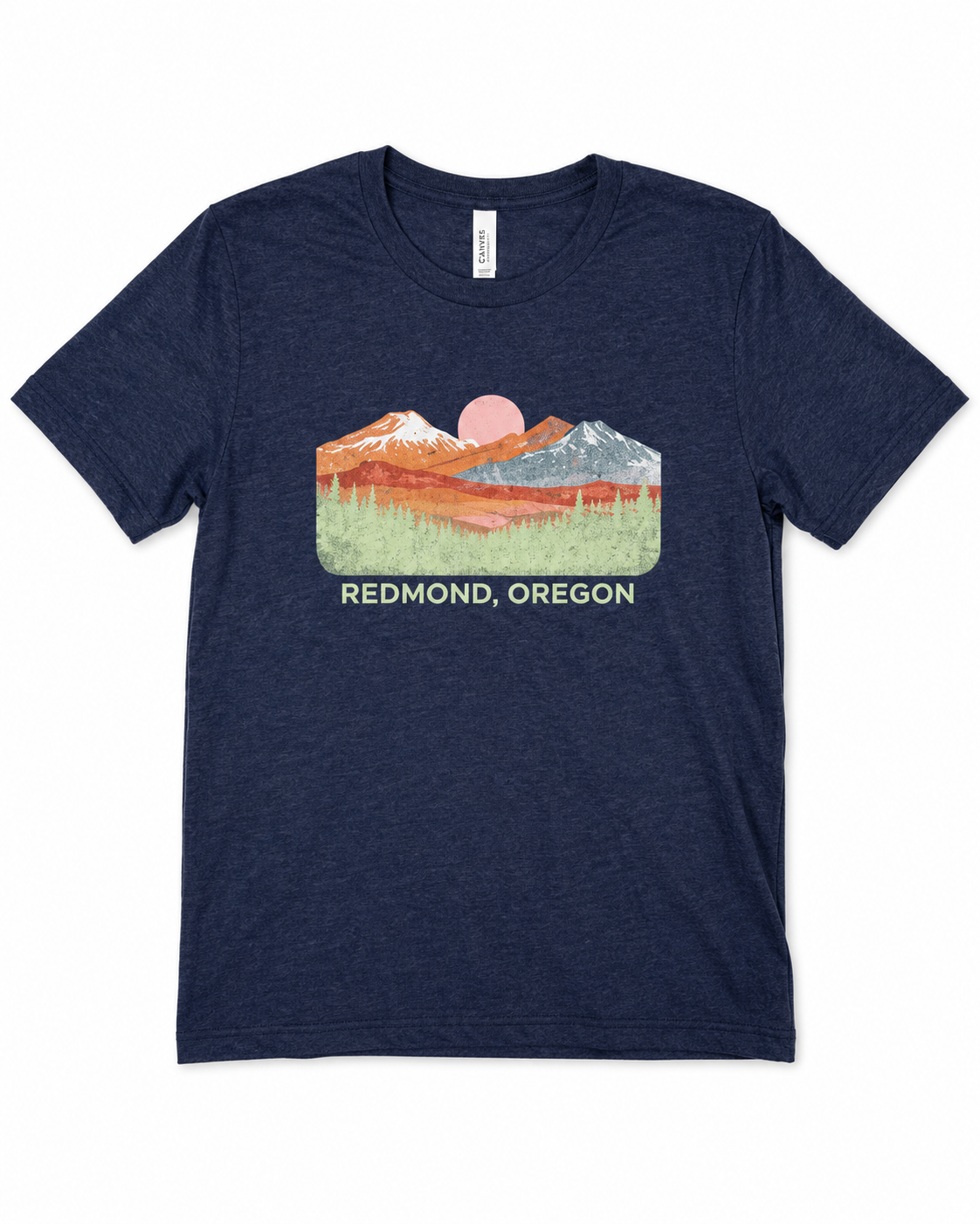 A heather navy blue short-sleeve t-shirt with a colorful graphic of mountains, a pink sun, and the text 'REDMOND, OREGON' printed on the chest.