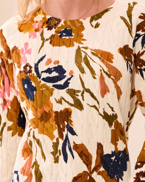 Floral patterned sweater with a cream background